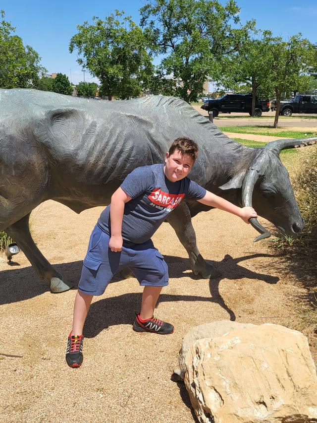 Conor squaring up to a life-size bronze bull sculpture